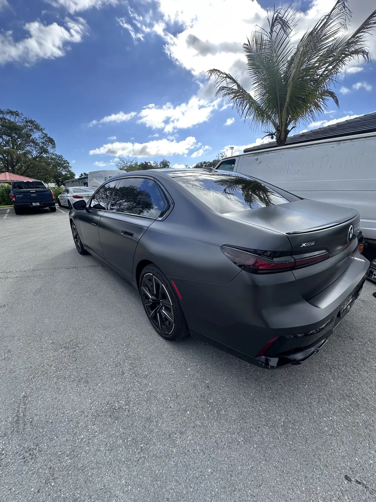Matte gray BMW 7 Series xDrive rear view after exterior detail in South Florida